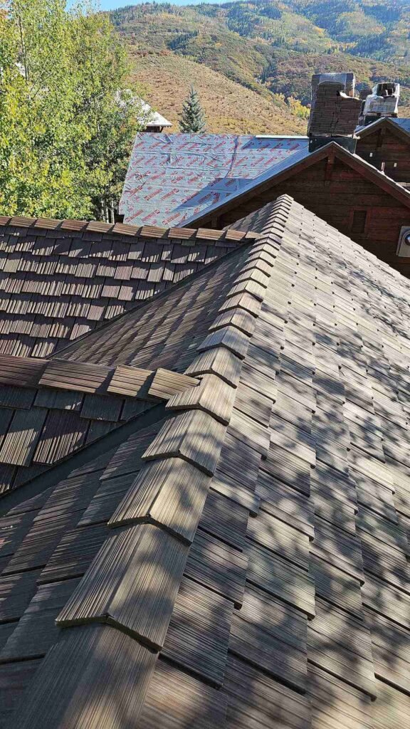 Architectural asphalt shingle roof installation close-up.